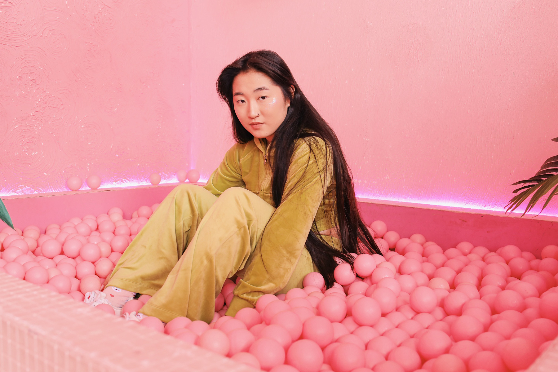 Woman in Green Suede Loungewear on Ball Pit